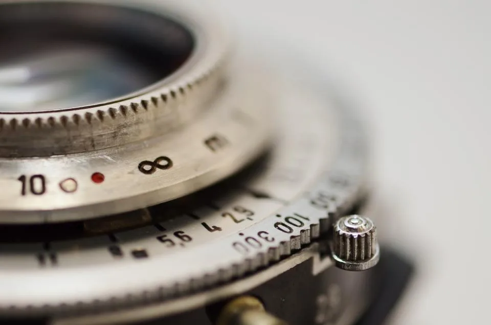 Close-up of a vintage camera lens with focus and aperture markings